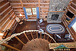 view of the living room from top of the spiral stairs to the loft.