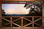a truly picturesque sunset over the smoky mountains framed by the deck of Grandpa's Cabin 