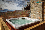 Relax in a Hot Tub while enjoying a beautiful mountain view on the side deck