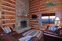 The warmth and character of Real Log walls, Large stone wood burning fireplace and soft leather sofas 
