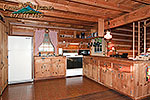 The full kitchen has an open view of the wood burning fireplace 